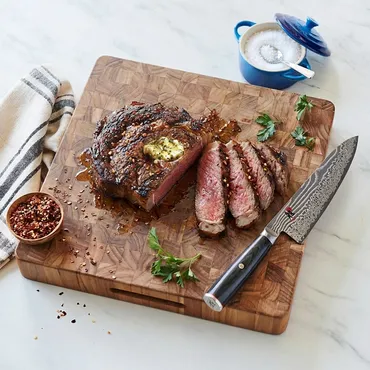 Bistecca All Fiorentina (Steak Florentine) on wooden cutting board